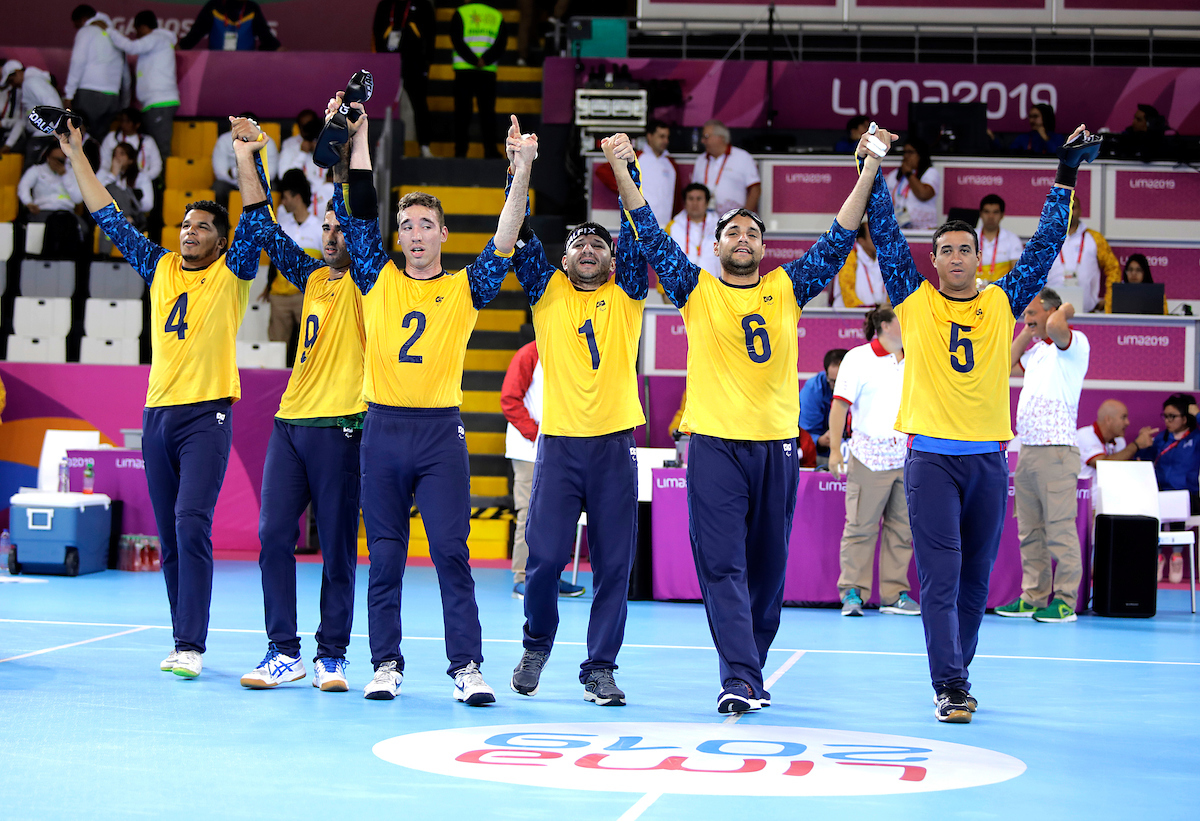 Brazilian men's goalball team celebrate by joining hands at Lima 2019